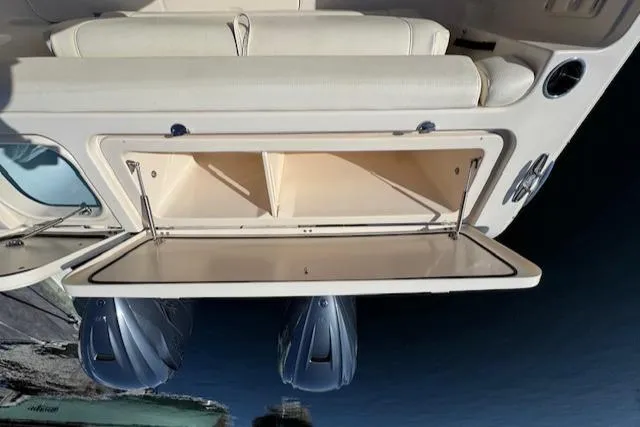 Slide: The Image of 2021 Grady-White Freedom 335 boat with open storage compartment and dual outboard motors. - 38