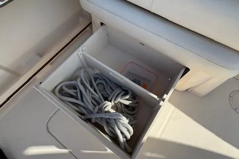 Slide: The Image of Storage compartment with rope on a 2021 Grady-White Freedom 335 boat. - 43