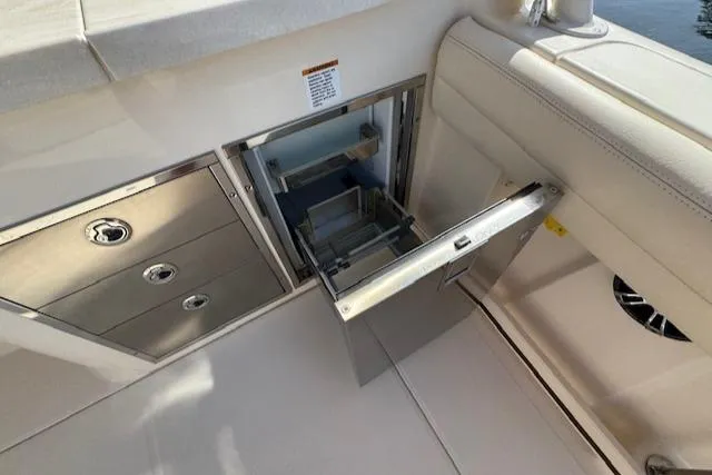 Slide: The Image of 2021 Grady-White Freedom 335 boat interior with open storage compartment and drawers. - 45
