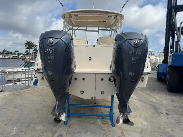 Slide: The Image of 2021 Grady-White Freedom 335 boat with twin Yamaha 425 V8 engines, docked under cloudy skies. - 8