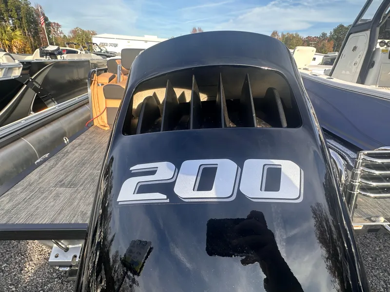 Slide: The Image of 2025 Avalon LSZ Quad Lounger Shift boat with powerful 200 engine, outdoor display. - 1