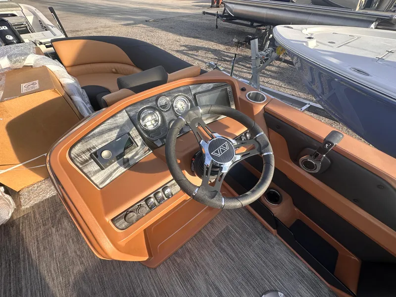 Slide: The Image of 2025 Avalon LSZ Quad Lounger Shift boat interior with steering wheel and dashboard controls. - 4