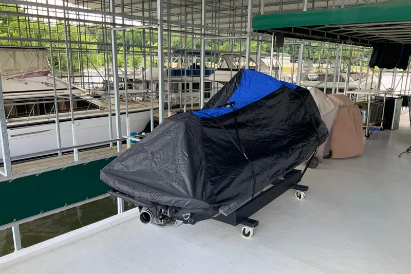 Slide: The Image of Covered boat in marina, Lakeview 16 x 65, 1997 model, docked with other vessels. - 11