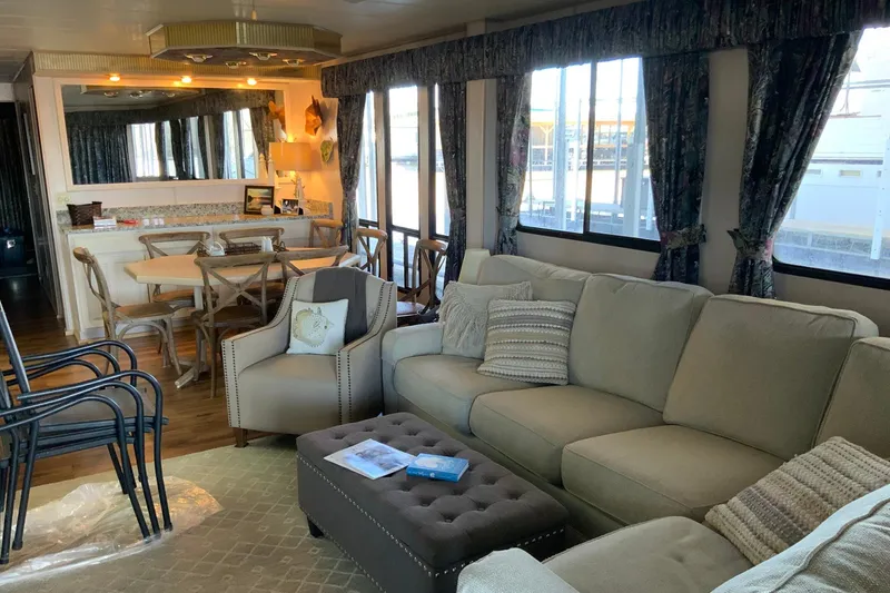 Slide: The Image of Cozy living area in a 1997 Lakeview 16 x 65 houseboat with elegant furnishings. - 14