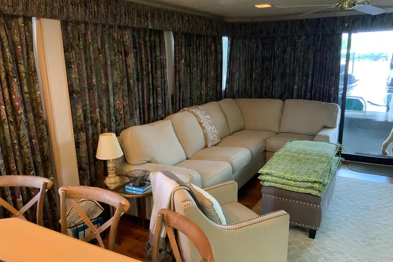 Slide: The Image of Cozy living area in a 1997 Lakeview 16 x 65 houseboat with beige sectional sofa. - 15