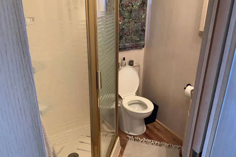 Slide: The Image of Compact bathroom with shower and toilet in a 1997 Lakeview 16 x 65 model. - 28