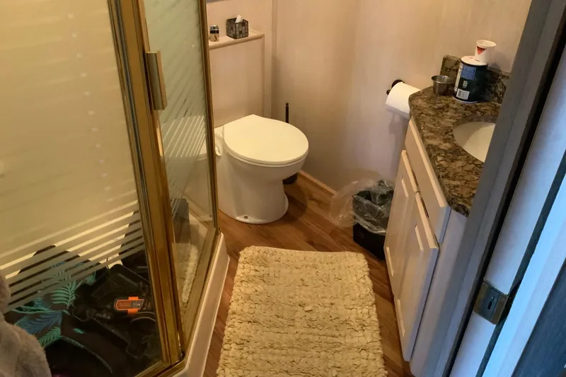 Slide: The Image of Bathroom in 1997 Lakeview 16 x 65 model with shower, toilet, and granite countertop. - 29