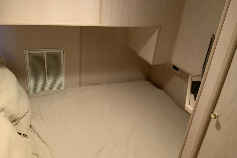 Slide: The Image of Cozy bedroom in 1997 Lakeview 16 x 65 houseboat with beige bedding. - 33