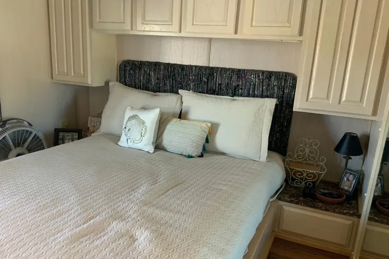 Slide: The Image of Cozy bedroom in 1997 Lakeview 16 x 65 model with white bedding and decorative pillows. - 35