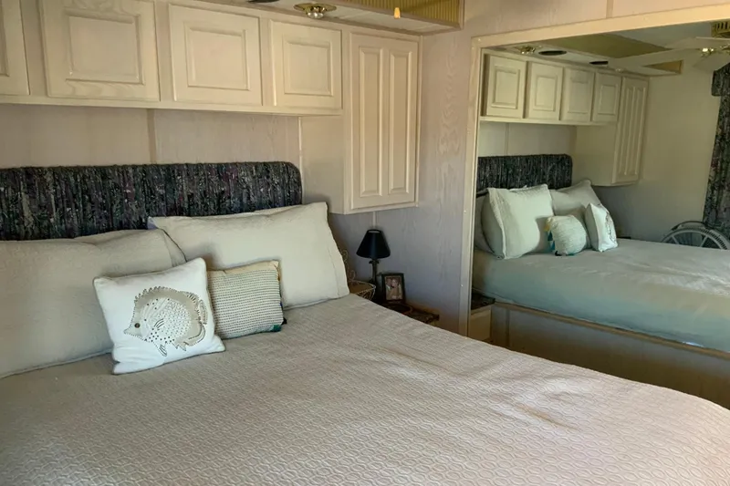 Slide: The Image of Cozy bedroom in 1997 Lakeview houseboat with mirrored closet and decorative pillows. - 36