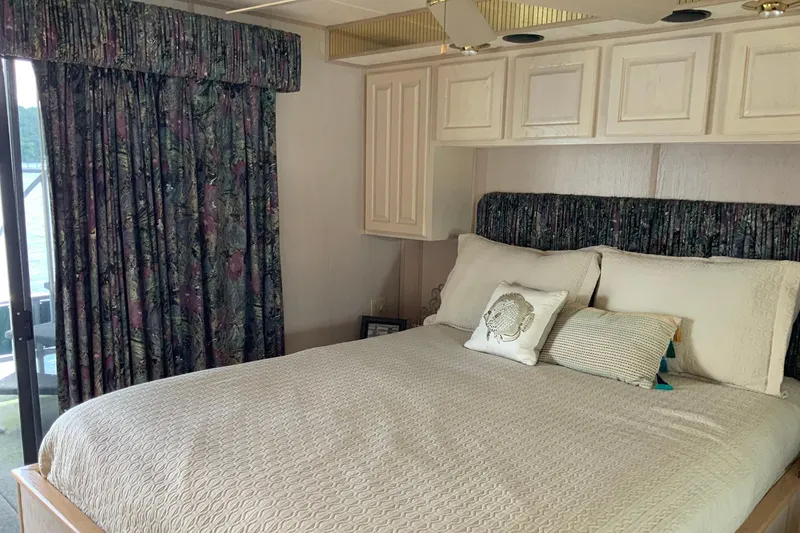 Slide: The Image of Cozy bedroom in 1997 Lakeview houseboat with floral curtains and plush bedding. - 39