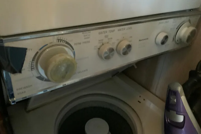 Slide: The Image of Control panel of a vintage washing machine with dials, partially obscured by a purple object. - 43