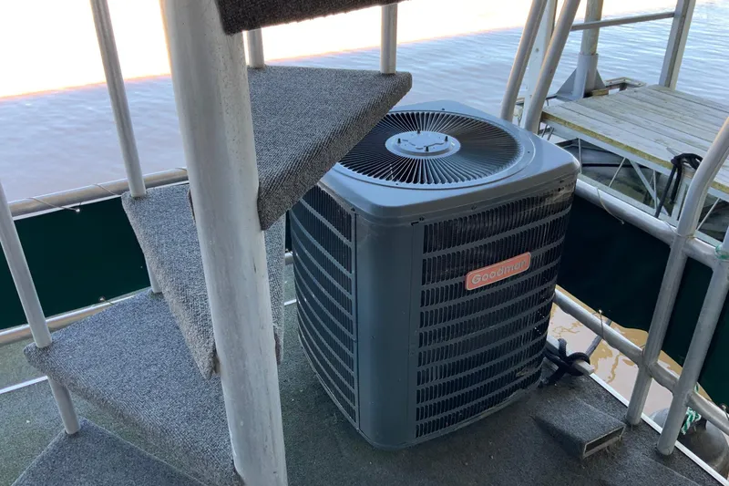 Slide: The Image of Outdoor air conditioning unit on a 1997 Lakeview 16 x 65 houseboat near spiral staircase. - 47