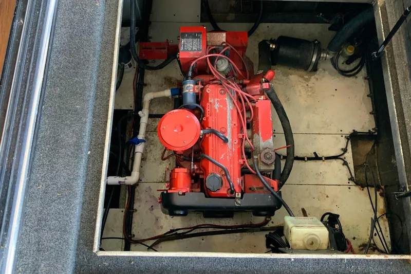 Slide: The Image of Engine compartment of a 1997 Lakeview 16 x 65 houseboat, featuring a red engine. - 48