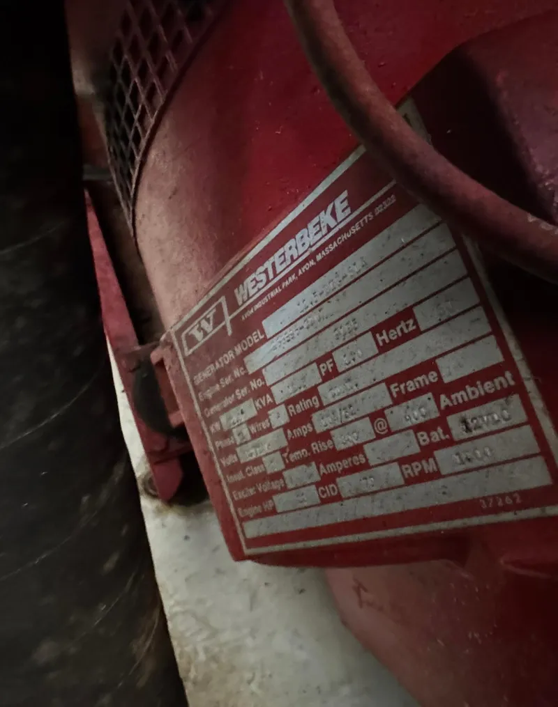 Slide: The Image of Close-up of a red Westerbeke engine label on a 1997 Lakeview 16 x 65 model. - 51