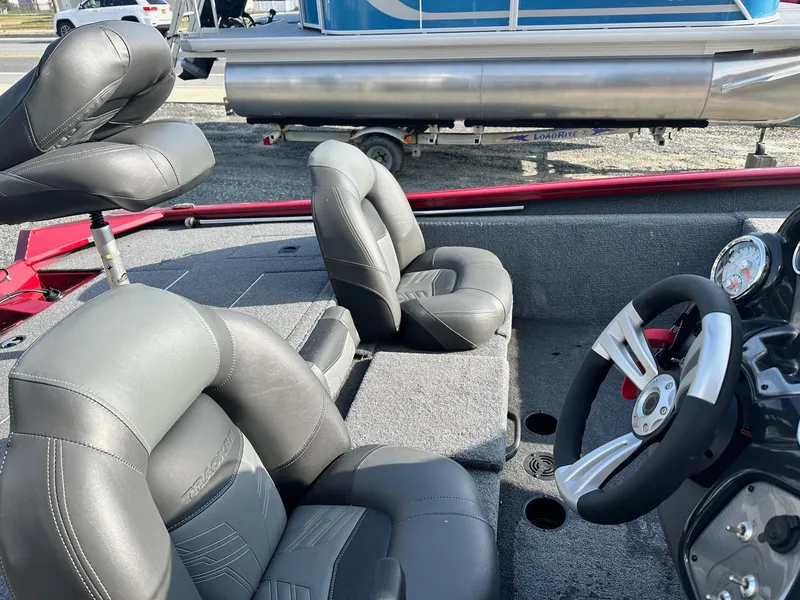 Slide: The Image of 2019 Tracker TXW175 Tournament Edition boat interior with gray seating and steering wheel. - 3