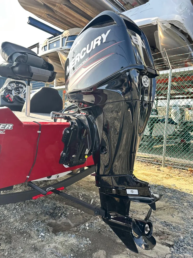 Slide: The Image of 2019 Tracker TXW175 Tournament Edition with Mercury outboard motor, parked outdoors. - 9