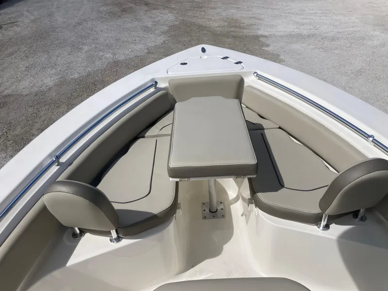 Slide: The Image of 2022 Key West 219fs boat interior with cushioned seating and table. - 10