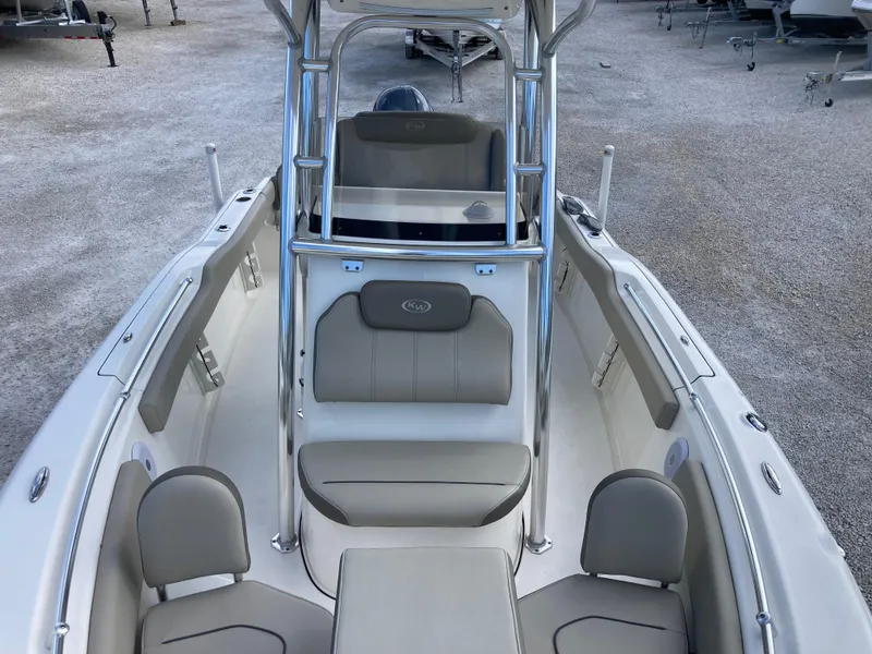 Slide: The Image of 2022 Key West 219fs boat interior with seating and console, displayed on gravel surface. - 12