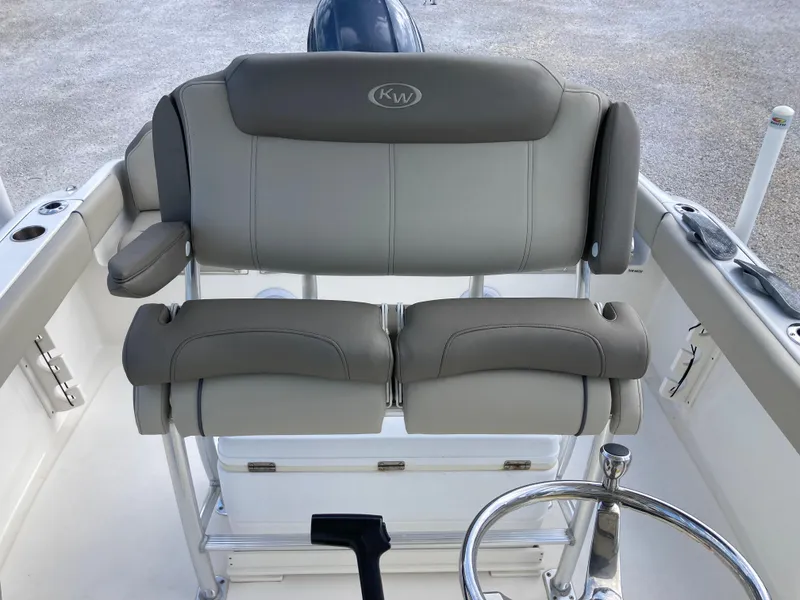 Slide: The Image of 2022 Key West 219fs boat with gray cushioned seating and steering wheel. - 13
