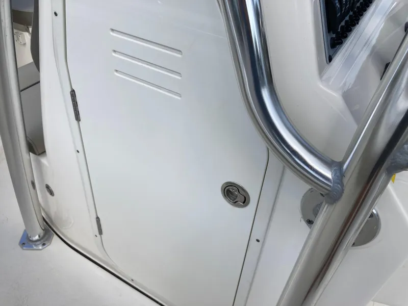Slide: The Image of 2022 Key West 219fs boat console with stainless steel railings and storage compartment. - 16