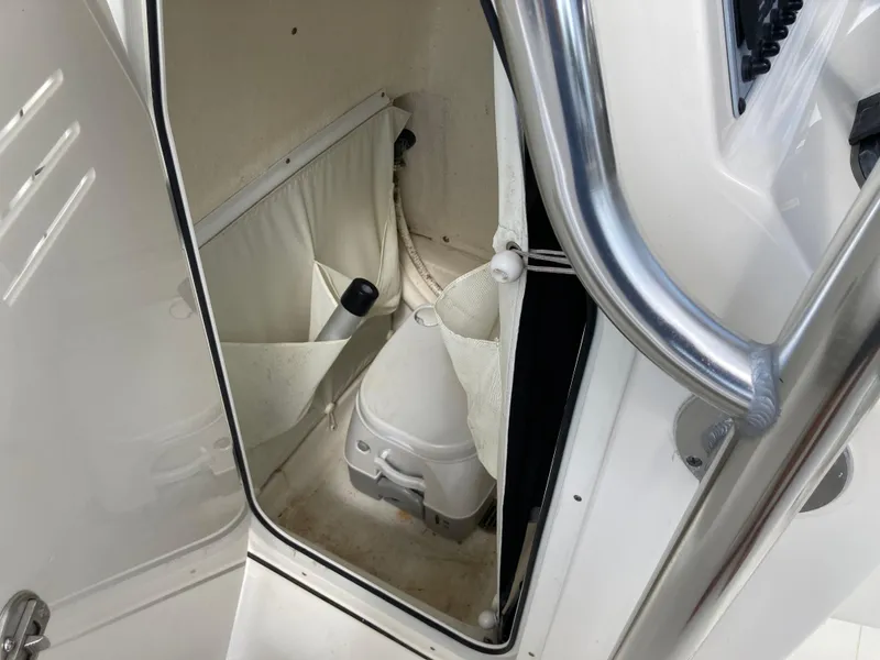 Slide: The Image of 2022 Key West 219fs boat interior storage compartment with white finish and accessories. - 17