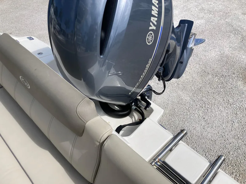 Slide: The Image of 2022 Key West 219fs boat with Yamaha outboard motor, beige seating, and ladder. - 20