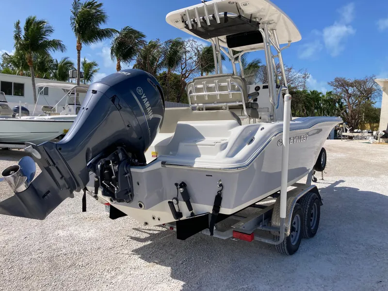 Slide: The Image of 2022 Key West 219fs boat on trailer with Yamaha outboard motor, parked outdoors. - 3