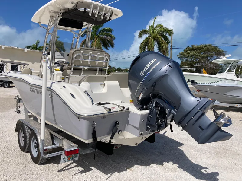 Slide: The Image of 2022 Key West 219fs boat with Yamaha outboard motor, parked on a trailer. - 4