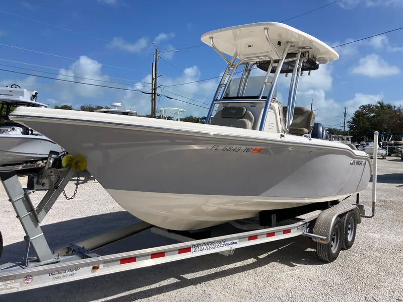Slide: The Image of 2022 Key West 219fs boat on trailer under clear blue sky. - 5