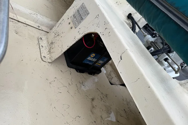 Slide: The Image of 2001 Carolina Skiff 17 Center Console interior with visible marine battery and wiring. - 6