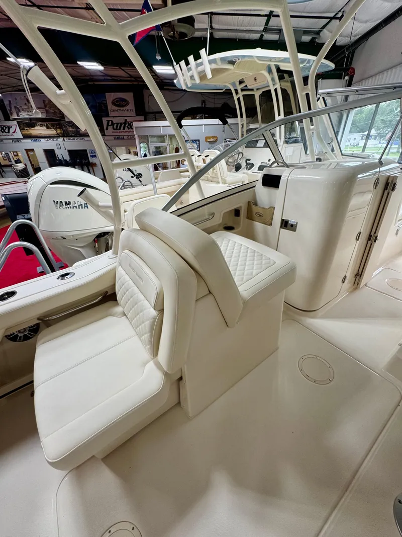 Slide: The Image of 2025 Grady-White Freedom 235 boat interior with Yamaha engine, featuring luxurious seating. - 10