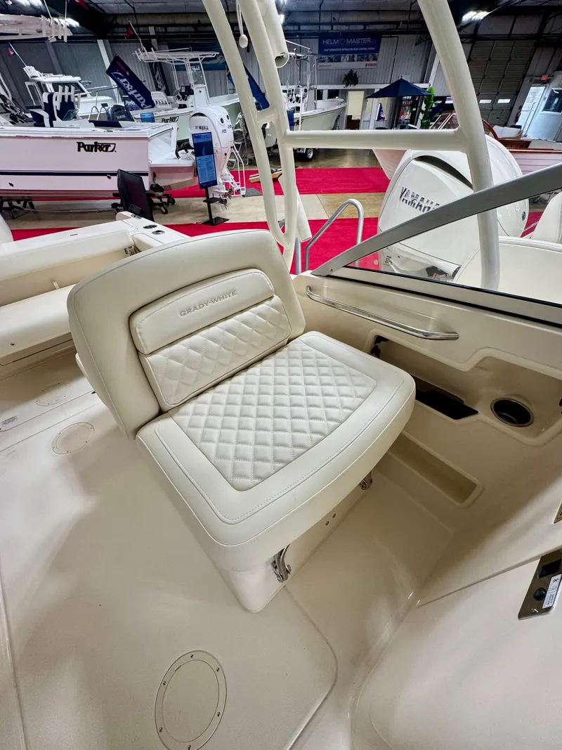Slide: The Image of 2025 Grady-White Freedom 235 boat interior with cushioned seating and elegant design. - 11