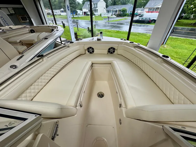 Slide: The Image of 2025 Grady-White Freedom 235 boat interior with cream seating and modern design. - 13
