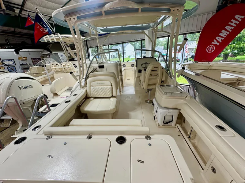 Slide: The Image of 2025 Grady-White Freedom 235 boat interior with Yamaha engine in showroom. - 3