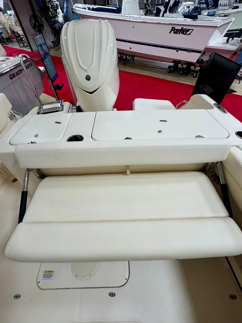 Slide: The Image of 2025 Grady-White Freedom 235 boat interior with seating and engine, showcased indoors. - 5