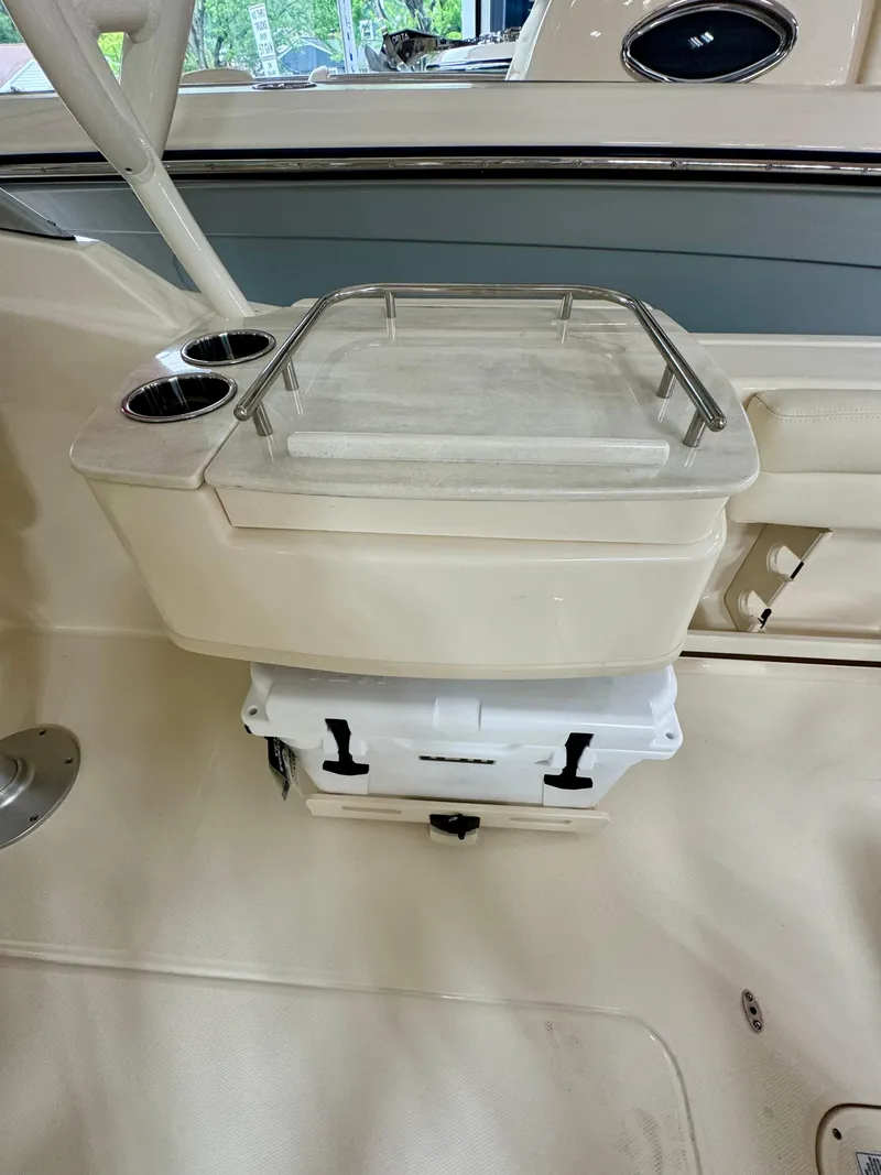 Slide: The Image of 2025 Grady-White Freedom 235 boat interior with storage compartment and cup holders. - 6