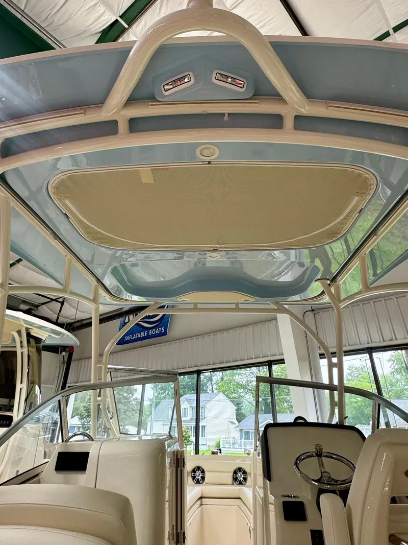 Slide: The Image of 2025 Grady-White Freedom 235 boat interior, featuring helm and seating area. - 8