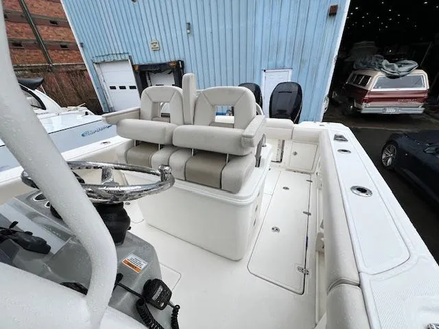 Slide: The Image of 2016 Boston Whaler 250 Outrage boat interior with dual seating and steering wheel. - 11