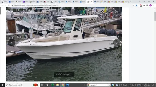 Slide: The Image of 2016 Boston Whaler 250 Outrage boat docked in marina, side view. - 2