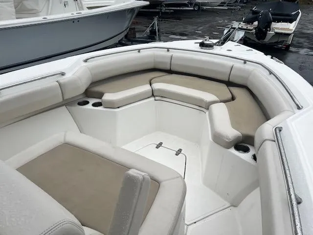 Slide: The Image of 2016 Boston Whaler 250 Outrage boat with cushioned seating and cup holders. - 23