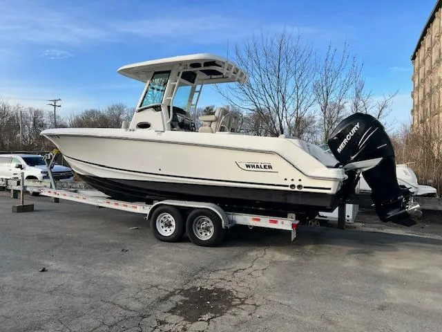 Slide: The Image of 2016 Boston Whaler 250 Outrage boat on trailer, parked outdoors. - 4