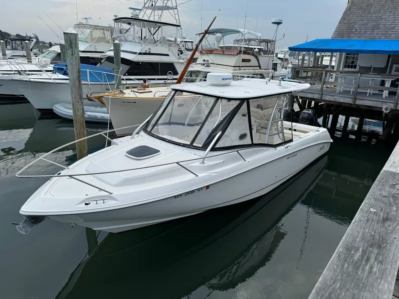 Slide: The Image of 2008 Boston Whaler 320 Outrage Cuddy Cabin docked at marina, surrounded by other boats. - 0