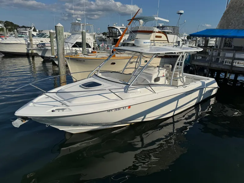 Slide: The Image of 2008 Boston Whaler 320 Outrage Cuddy Cabin docked at marina under clear sky. - 1