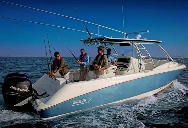 Slide: The Image of 2008 Boston Whaler 320 Outrage Cuddy Cabin with anglers on open water. - 11