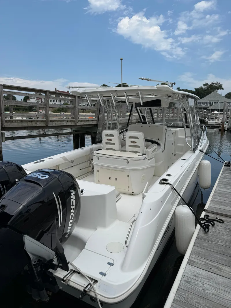 Slide: The Image of 2008 Boston Whaler 320 Outrage Cuddy Cabin docked, featuring dual Mercury engines. - 3