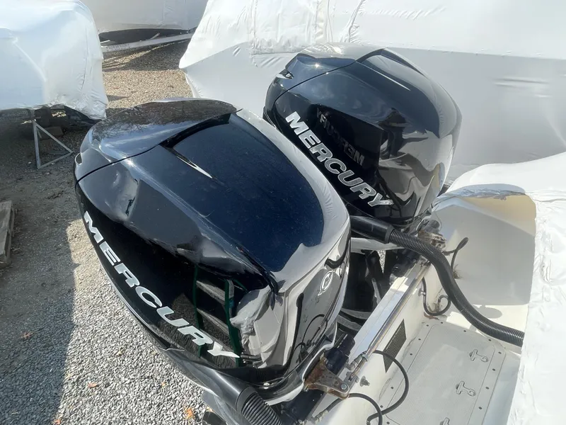 Slide: The Image of Twin Mercury outboard engines on a 2008 Boston Whaler 320 Outrage Cuddy Cabin. - 4