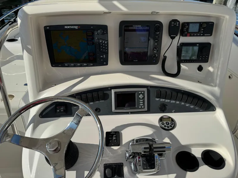 Slide: The Image of 2008 Boston Whaler 320 Outrage Cuddy Cabin dashboard with navigation and control systems. - 6