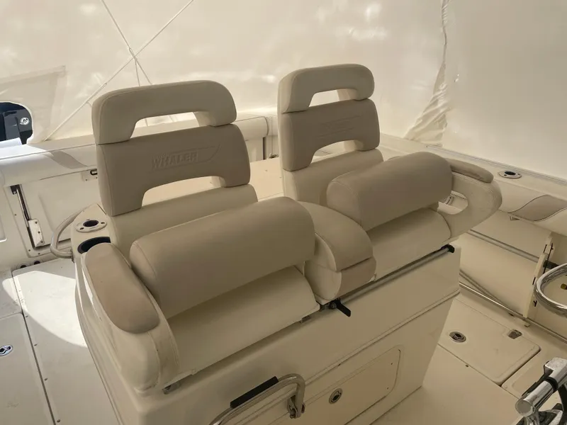 Slide: The Image of 2008 Boston Whaler 320 Outrage Cuddy Cabin interior with cushioned seating. - 9
