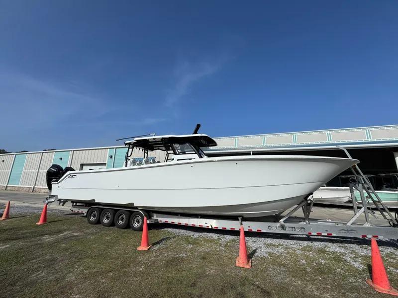 Slide: The Image of 2025 Invincible 46 Catamaran on trailer, parked outdoors with blue sky background. - 10